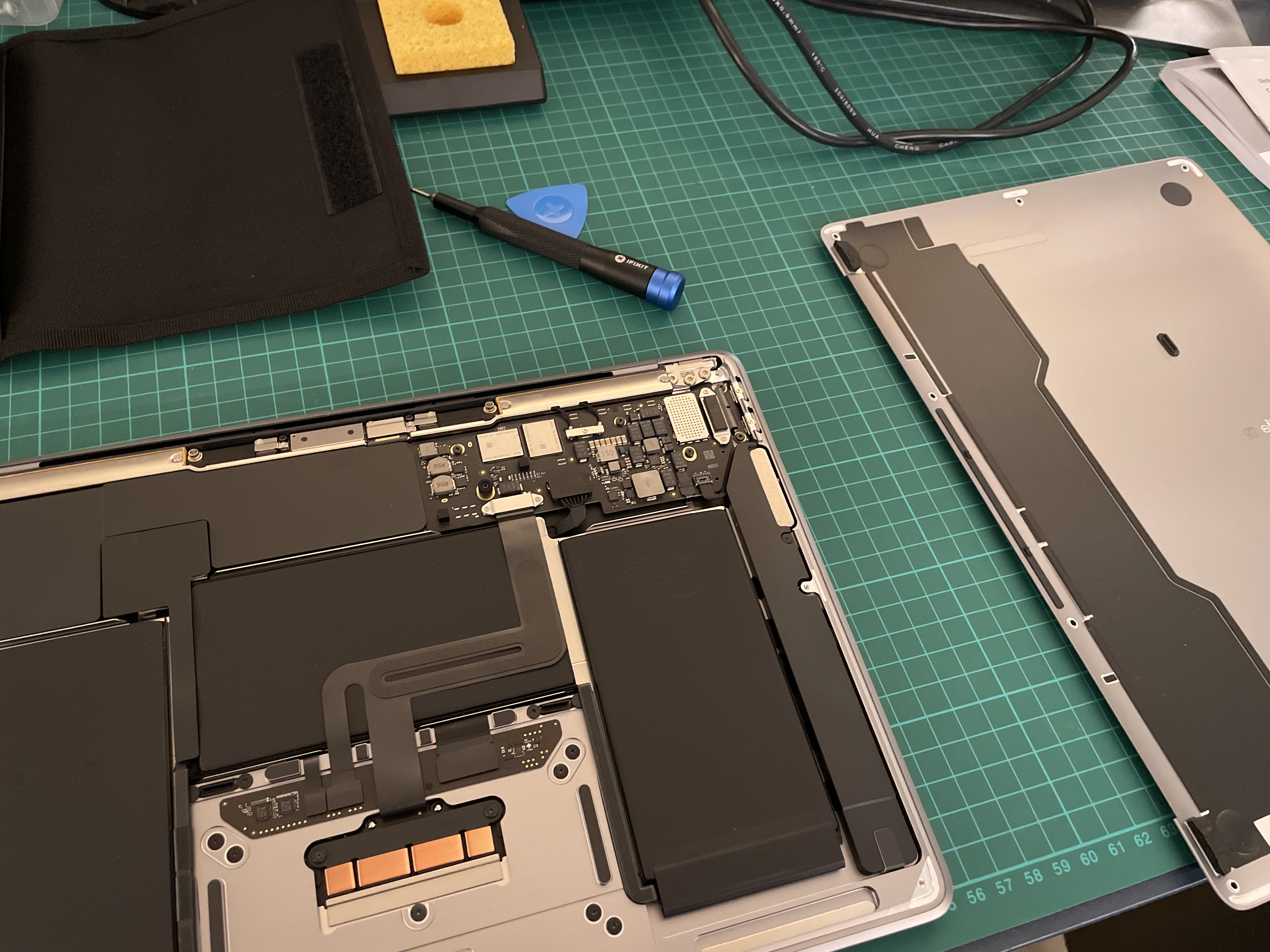 An Apple MacBook Air with the cover removed and a direct view of its interior. by Tobias Lieshoff